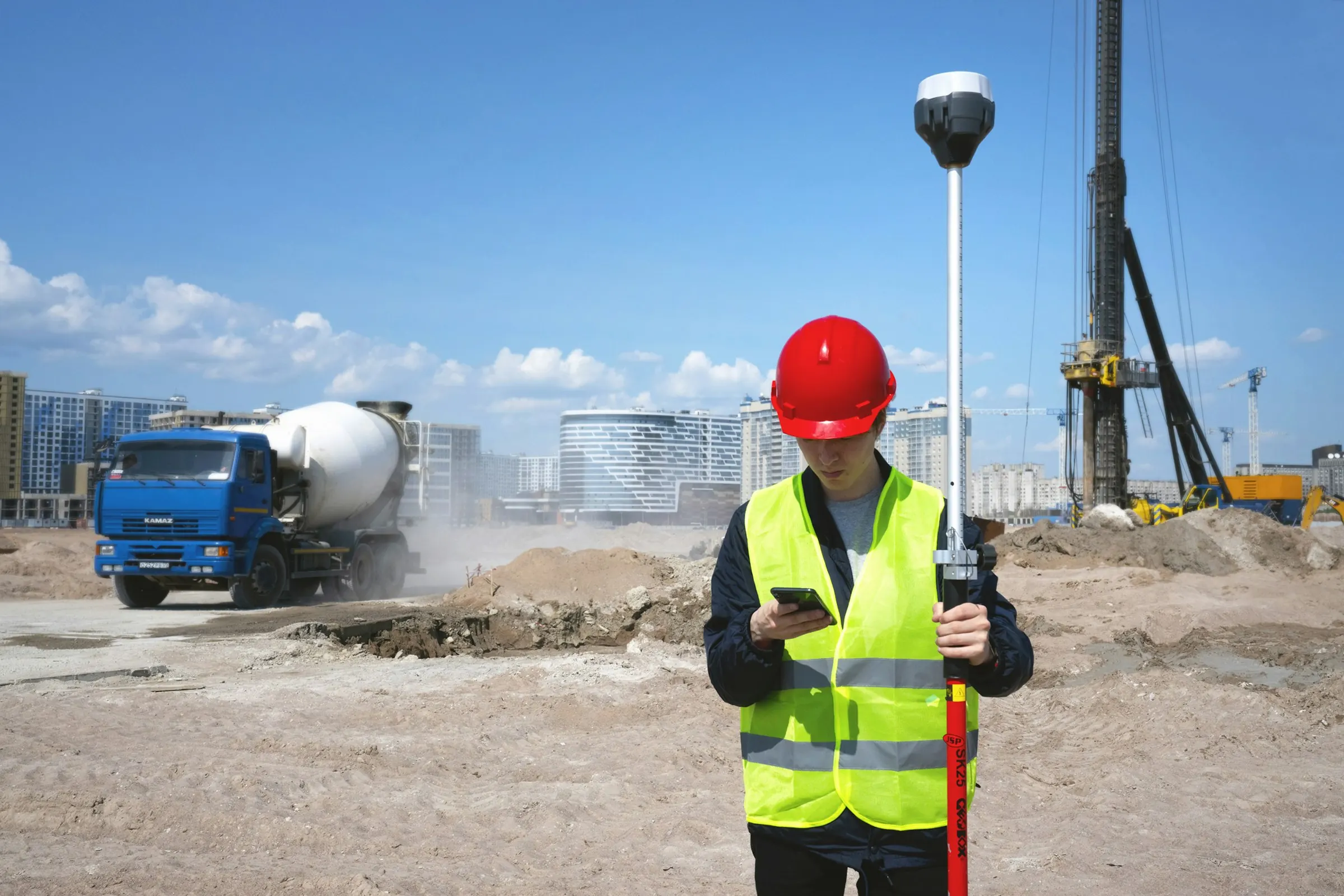 Surveyor with a leveling staff on a Geo-Build construction site